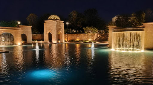 Underwater fountain lights brighten water pool with retro architectural fountain landscape