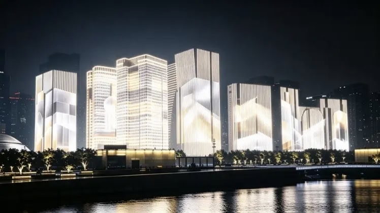 Synchronized media facade lighting plays soft animations across a waterfront building cluster